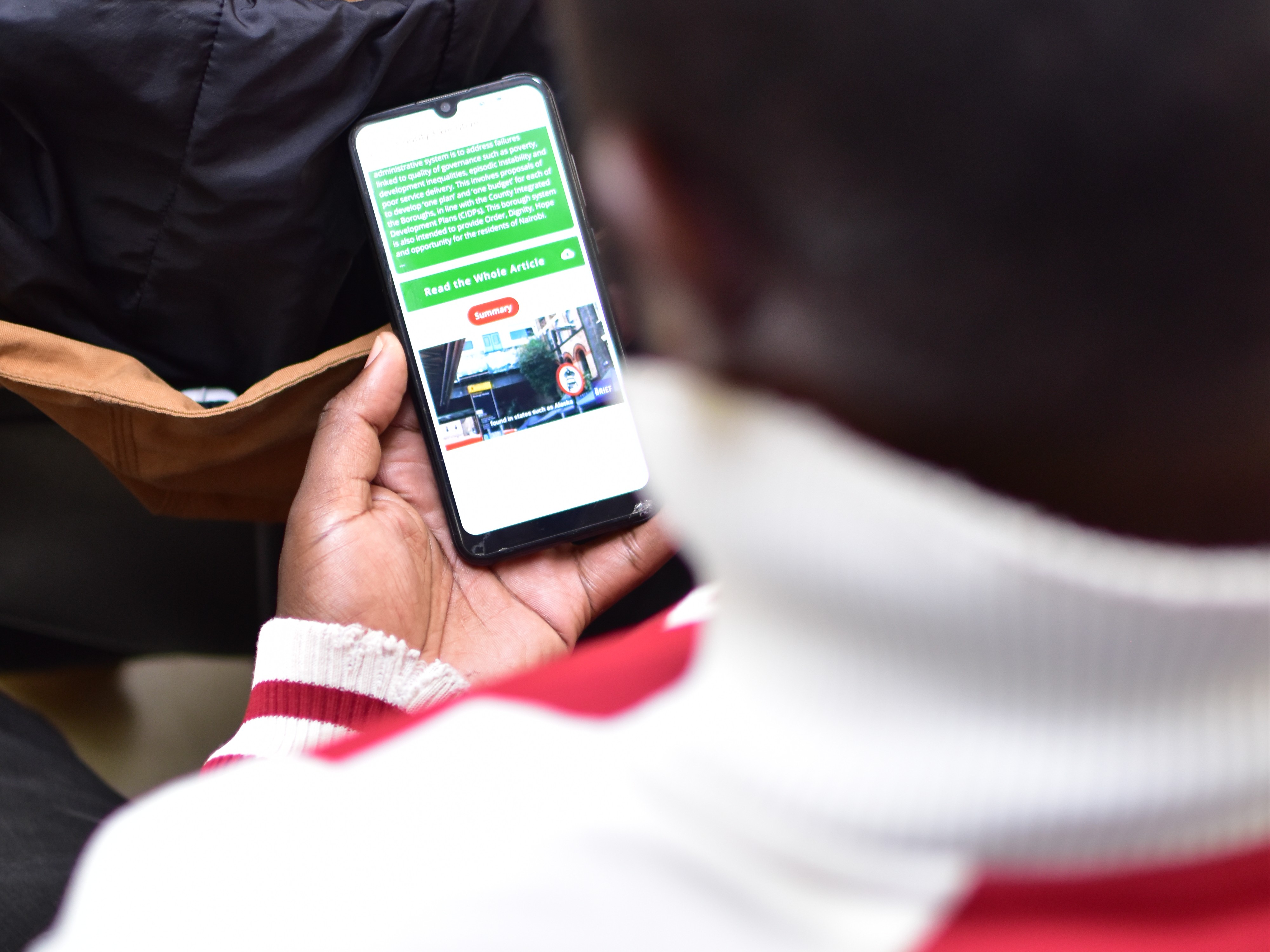 A photorealistic image depicting a virtual town hall meeting on a large screen. A diverse group of people is shown participating remotely, each in their own homes or offices. The lighting is warm and inviting, creating a sense of connection and community. The camera angle is a medium shot, capturing the interaction between the participants. Technical specs: 4K resolution, high quality, photorealistic.