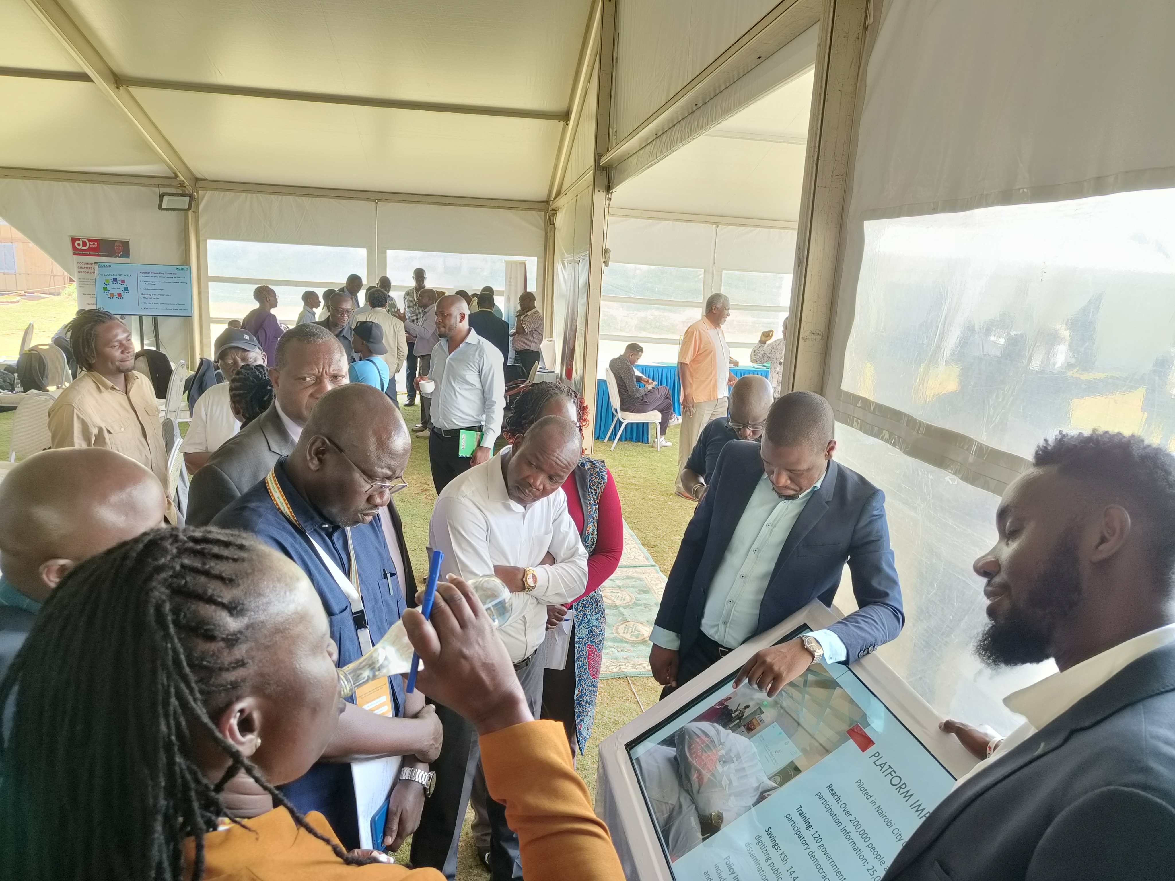 A photorealistic image of a software development team collaborating on a complex project. The scene is set in a modern office environment with large monitors displaying code and design mockups. The lighting is bright and focused, highlighting the team's concentration and expertise. The camera angle is a medium shot, capturing the interaction between the team members. Technical specs: 4K resolution, high quality, photorealistic.