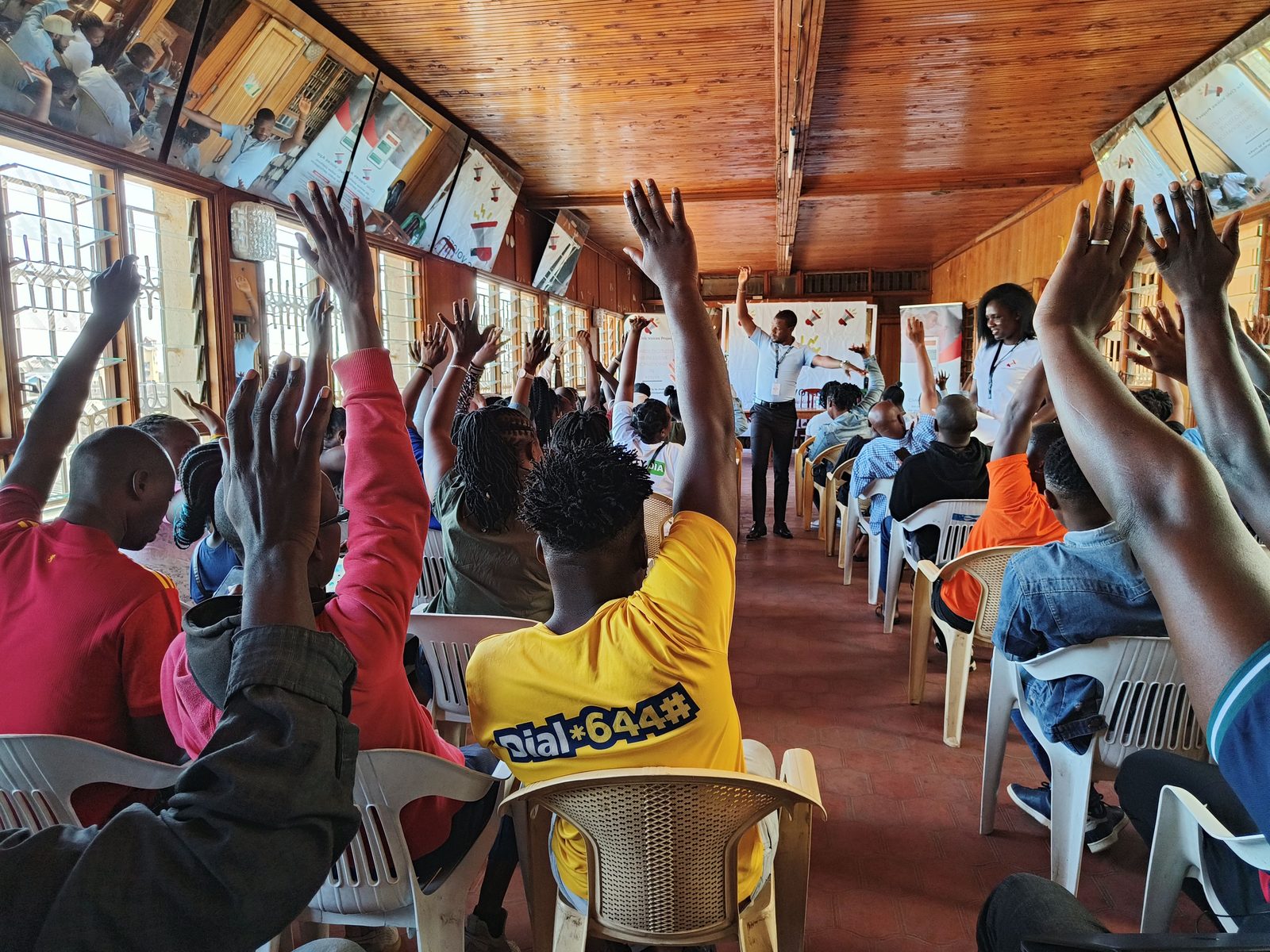 Citizens raising hands to contribute at a public participation forum